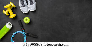 Fitness equipment on a dark background with copy space