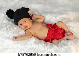 newborn baby in mouse costume on fur bed newborn baby in mouse costume on fur bed