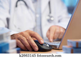 Doctor preparing online internet prescription Doctor preparing online internet prescription