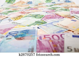 Lots of euro banknotes scattered over the table