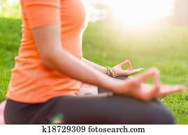Active woman doing yoga poses at sunset