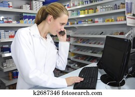 pharmacist using computer and telephone pharmacist using computer and telephone