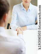businesswoman and businessman shaking hands