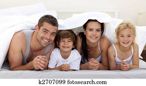 Family playing in parent's bed