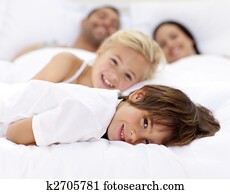 Family resting in parent's bed Family resting in parent's bed