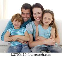Family sitting on sofa together