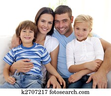 Happy family sitting on sofa at home Happy family sitting on sofa at home