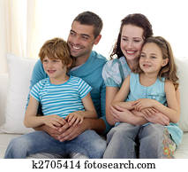 Happy family sitting on sofa together Happy family sitting on sofa together