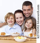 Portrait of happy family having breakfast