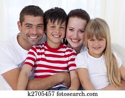 Portrait of smiling family sitting on sofa together