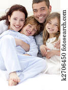 Portrait of young family lying in bed Portrait of young family lying in bed