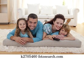 Smiling family on floor in living-room