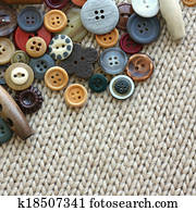 Variety of Vintage Buttons Scattered on Knit Fabric Background Variety of Vintage Buttons Scattered on Knit Fabric Background
