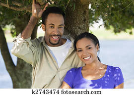 Happy Romantic African American Couple Smiling Under A Tree