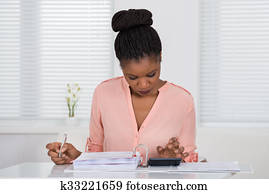 Woman Calculating Invoice With Calculator
