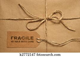 Brown shipping parcel tied with twine and tag for copy space
