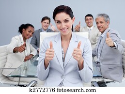 Happy business team with thumbs up
