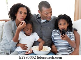 Afro-American family watching a film at home