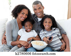 Afro-American family watching television at home