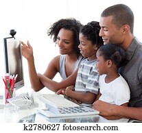 Afro-American family working with a computer at home
