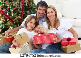 Happy family holding Christmas gifts