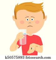 Unhappy little boy with glass of water shows two pils Unhappy little boy with glass of water shows two pils