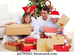 Young family having fun with Christmas gifts
