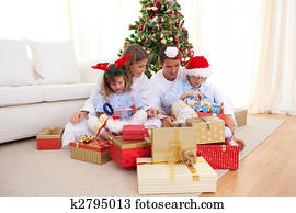 Young family unpacking Christmas presents
