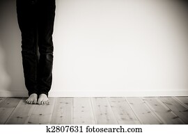 Barefeet boy alone in his room