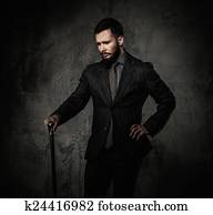 Handsome well-dressed with walking stick 