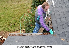 Man cleaning gutters Man cleaning gutters