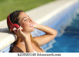 Relaxed woman listening to the music with headphones