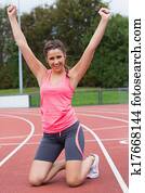 Toned young woman cheering on the running track