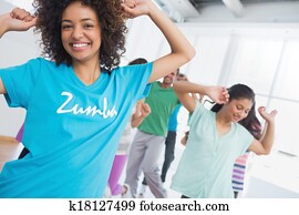 Fitness class and instructor doing pilates exercise Fitness class and instructor doing pilates exercise