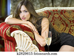 rich woman on a red expensive sofa