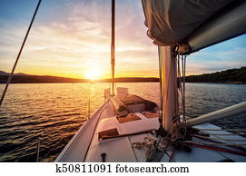 Close-up of yacht sailing against beautiful sunset