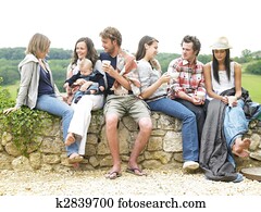Group of People Relaxing Outdoors With Coffee