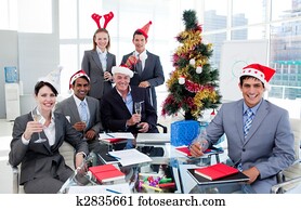 Portrait of a happy business team toasting with Champagne at a Christmas party in the office Portrait of a happy business team toasting with Champagne at a Christmas party in the office