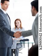 International businessmen greeting each other at a job interview in an office International businessmen greeting each other at a job interview in an office