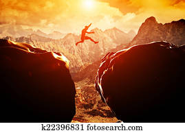 Man jumping over precipice