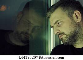 Man near the window Man near the window