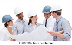 Cheerful architects holding a blueprint