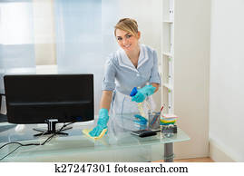 Maid Cleaning Desk In Office Maid Cleaning Desk In Office