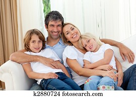 Smiling family relaxing on the sofa