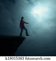 Woman walking off cliff
