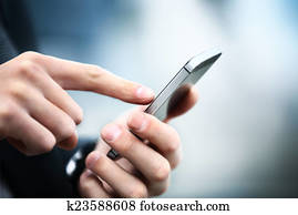 Close up of a man using mobile smart phone