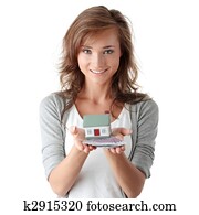 Woman holding euros bills and house model 