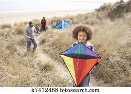 Family Having Fun With Kite In Sand Dunes Family Having Fun With Kite In Sand Dunes