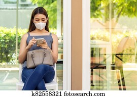 Asian woman customer with face mask waiting for restaurant queue