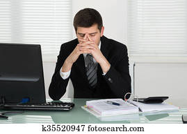 Stressed Businessman Calculating Bill